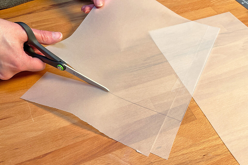 Creeper-Deko-Leuchte basteln beim Zuschneiden von Transparentpapier mit der Schere als Abdeckung für die Mosaik-Leuchte