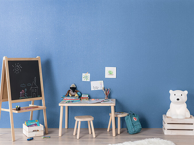 An einer mit Magnetfarbe gestrichenen Wand im Kinderzimmer lassen sich leicht Kinderbilder aufhängen und schnell wieder austauschen