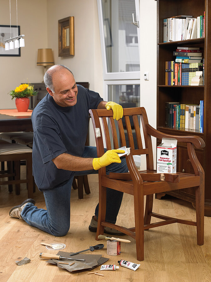 Stuhl mit Reparaturspachtel reparieren