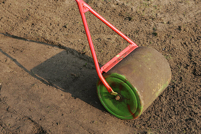 Gartenwalze-glaettet-frischen-Boden
