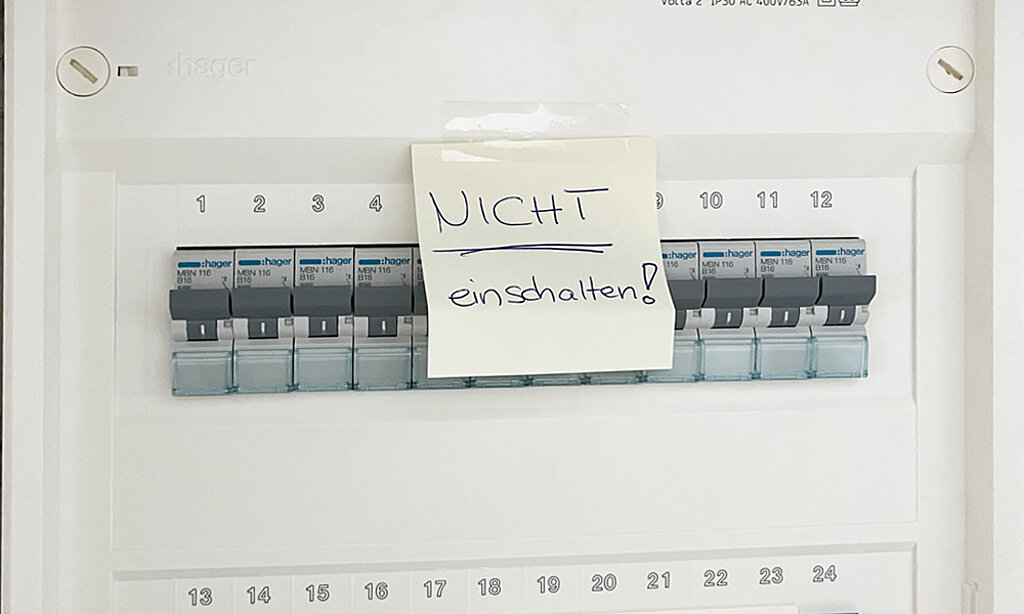 Sicherung im Sicherungskasten ist abgeschaltet und mit einem Post-it gegen Wiedereinschalten gesichert, auf dem Zettel steht -nicht einschalten-