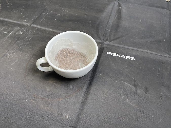 Tassengarten basteln und Vliesstück erneut zurechtschneiden für die Drainageschicht in der Tasse